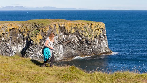 Woman on the edge of the cliff - Westcoast of Iceland