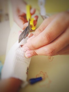 Nurse cut gauze for removing saline needle (selective focus and blur)