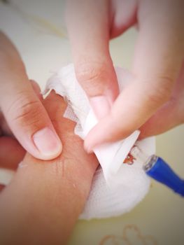 Nurse cut gauze for removing saline needle (blur)