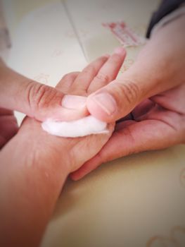 Nurse removed saline needle and use cotton for stop the bleeding (blur)