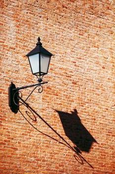 old vintage retro street lamp on brick wall with copy space background