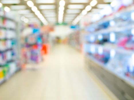 Blurred colorful supermarket products on shelves - background with shallow DOF