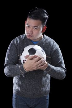 face of soccer lover holding football ball isolated black background use for sport and people activities theme