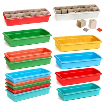 color plastic containers with pots for seedling on the white isolated background