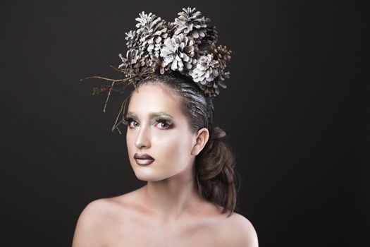 Beautiful Sexy Slim Elegant Girl with Bright Makeup in the New Year  Wreath of Christmas Tree and Pine Cones