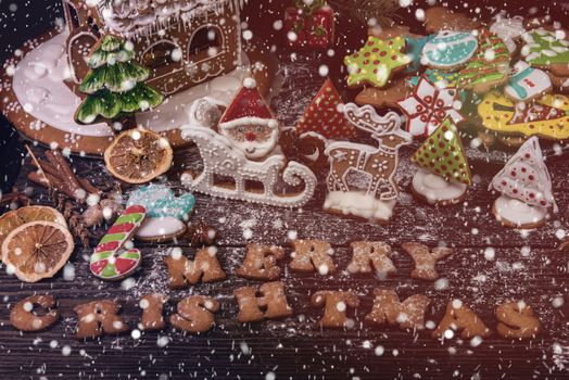 Gingerbreads for new years and christmas on wooden background, xmas theme