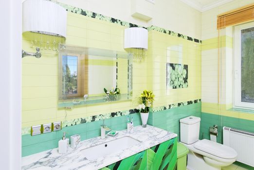 Bathroom design with beautiful green grass print on bath cabinet