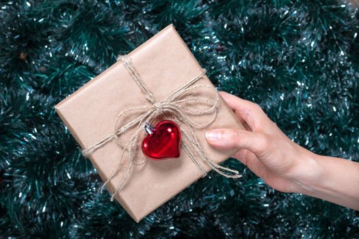 Packaging holiday gifts.Young girl packs a Christmas gift with Christmas decorations. Top view