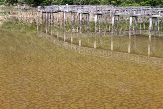 The soil dried had under the flooded and reflection bridge wood. Under water see through of Drought still see traces