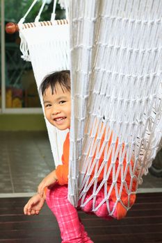 face of children sitting in clothes cradle and smiling use for family relaxing time and warm home 