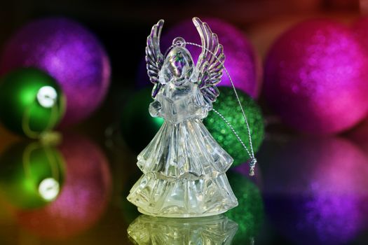 Crystal Angel on the background of Christmas balls. new Year decoration. Christmas ornaments, christmas decoration