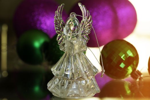 Crystal Angel on the background of Christmas balls. new Year decoration. Christmas ornaments, christmas decoration