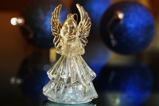 Crystal Angel on the background of Christmas balls. new Year decoration. Christmas ornaments, christmas decoration