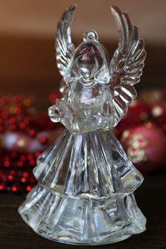 Crystal Angel on the background of Christmas balls. new Year decoration. Christmas ornaments, christmas decoration