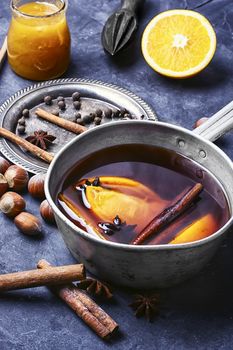hot drink based on red wine,orange and spices in saucepan