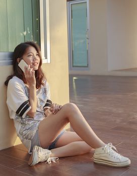 portrait of beautiful young and teen woman talking mobile phone with smiling face in home outdoor