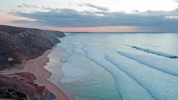 Aerial from rocks and ocean at Praia Vale Figueiras in Portugal