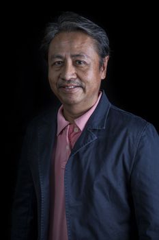 portrait head shot of smiling face with happiness emotion senior asian man with studio light 