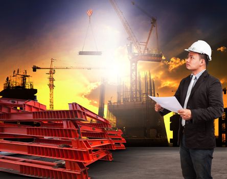 engineering man working in building construction site and reading plan ducument  use for construciton industrial business and land development topic