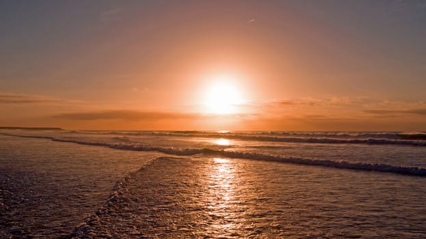 Aerial from ocean waves at twilight