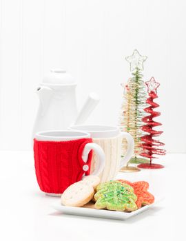 Plate of colorful festive christmas sugar cookies and coffee.