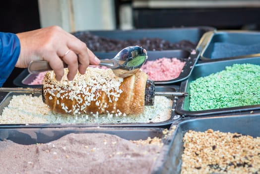 cake topped with white Sweet cereals during cooking