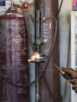 Welders were repairing cutting Shock absorbers of a car