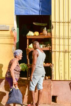 Trinidad, Cuba - 9 january 2016: woman buying vegetable at the market at the town of Trinidad on Cuba