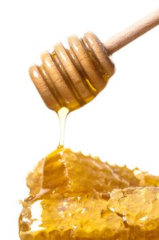 flowing honey with a spoon on white background