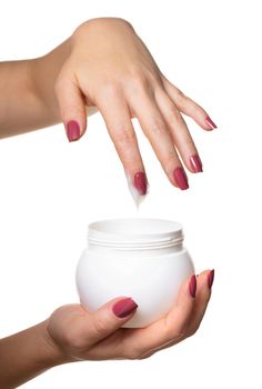 Hands with jar cosmetic cream on a white background