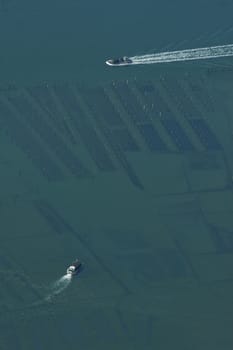 Aerial view of oyster boat returning to harbor , Arcachon, France