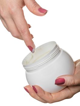 Hands with jar cosmetic cream on a white background