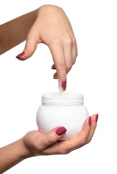 Hands with jar cosmetic cream on a white background