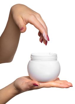 Hands with jar cosmetic cream on a white background