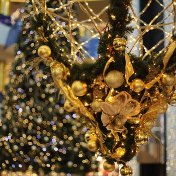 Golden decorative christmas baubles on christmas tree background