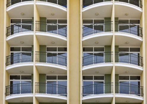 repeating pattern of windows and balcony.