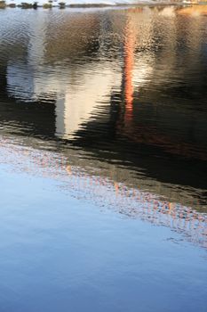 Abstract water surface of river with construction reflection