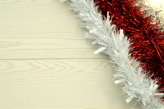 Three diagonal red and white garland on wooden background