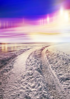 Snow covered road to north, polar lights in the sky