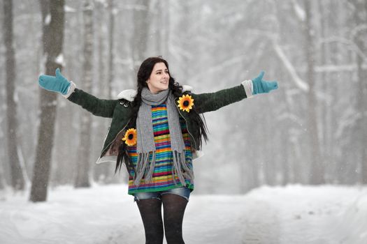 Beautiful young woman in a sweater on a winter walk in a park. Winter