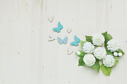 Jasmine flower handmade, heart and butterfly on wood background ( 12th August is Mother's day in Thailand)