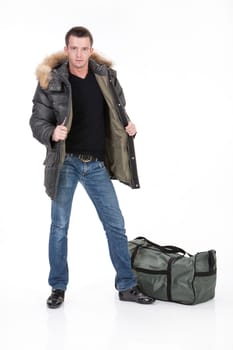 Young man in winter clothing on an isolated studio background