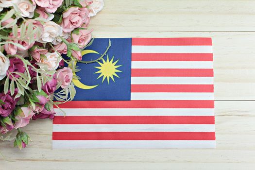 National day : Malaysia flag and flower on wood background