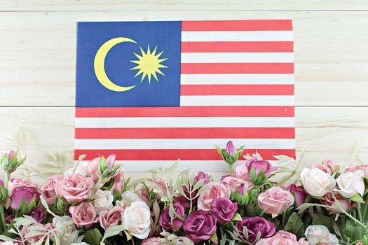 National day : Malaysia flag and flower on wood background