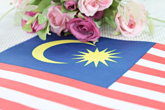 National day : Malaysia flag and flower on tablecloth