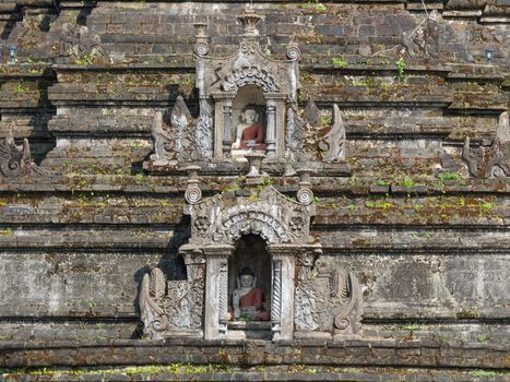 Detail of Sakya Man Aung, a pagoda in Mrauk U, the Rakhine State of Myanmar, with two small Buddha images in wall niches. 