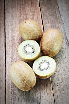 Fresh kiwi fruits on wooden background, selective focus