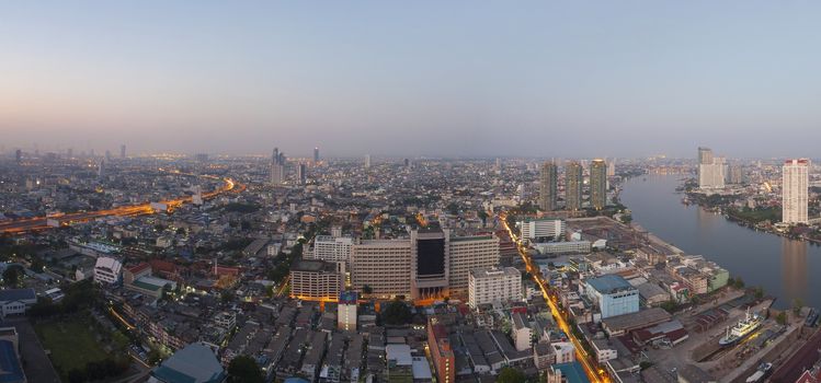 top view from high building roof morning light of bangkok capital of thailand looking to south east direction show glow up light of dawn on ground and over sky 