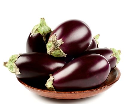 Arrangement of Raw Small Eggplants In Bowl isolated on White background. Focus on Foreground