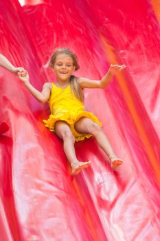 Child drives off the high inflatable trampoline